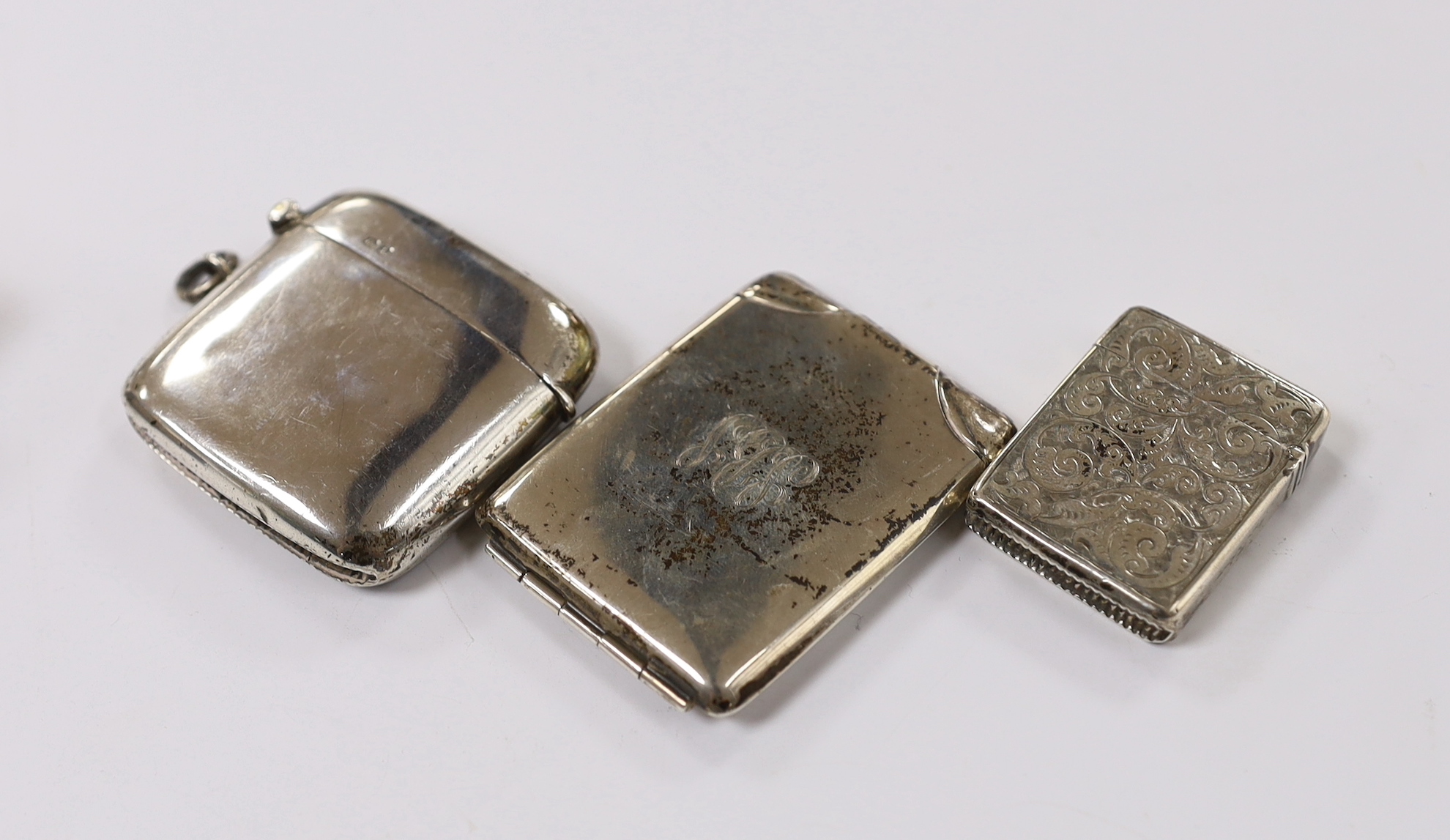 Two silver vesta cases, largest 49mm and two silver match sleeves.